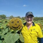 Tony Matchett from Savannah Ag Consulting with his one his sunflowers grown in Mareeba, Qld.